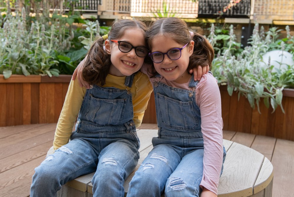 GOSH patients Iona and Beth in the sensory garden in the Sight and Sound Centre supported by Premier Inn