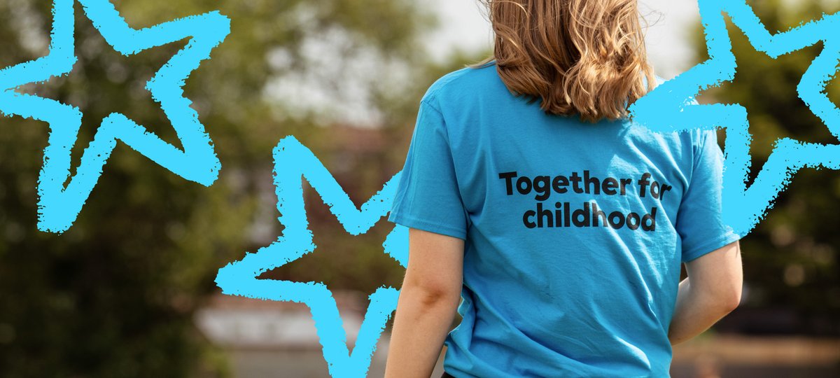 A fundraiser wears a t-shirt with Together for childhood written on the back. She is standing outside and facing away from the camera. Illustrations of stars overlay the image