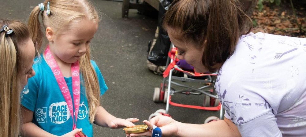 Amelia-Rose holds Beth's gold medal