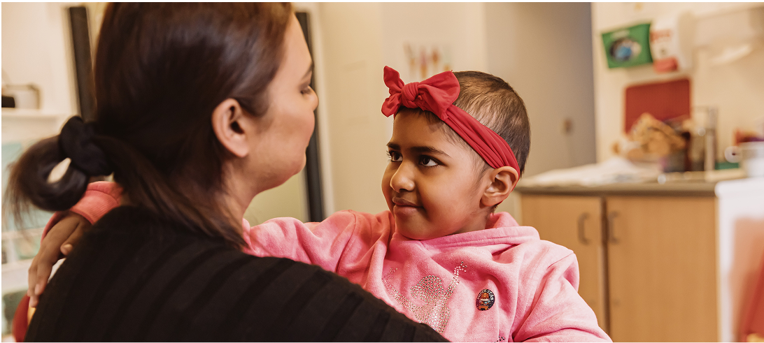 Close up of girl smiling and looking at her mother
