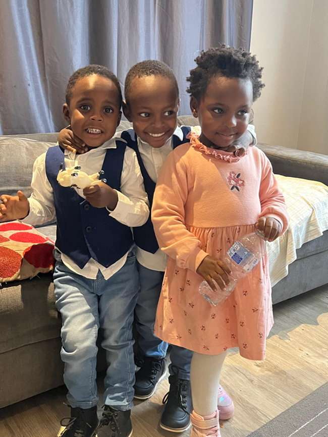 Two boys and a girl standing next to each other