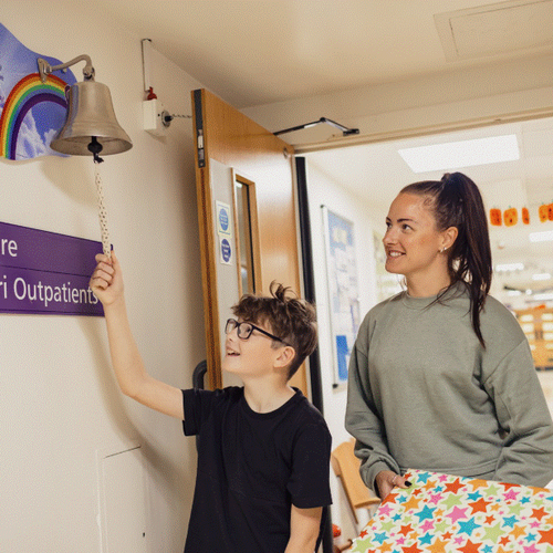 Boy ringing end of treatment bell