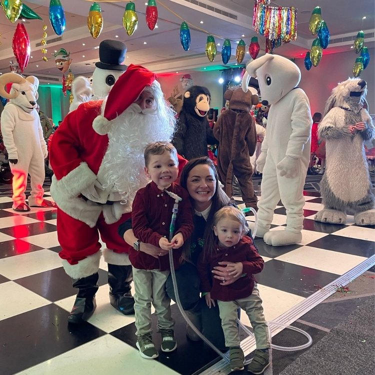 Henry and his mum and brother with Father Christmas at the GOSH Christmas party