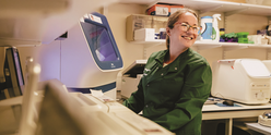 A woman laughing in a lab