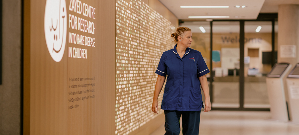A woman walking down a corridor