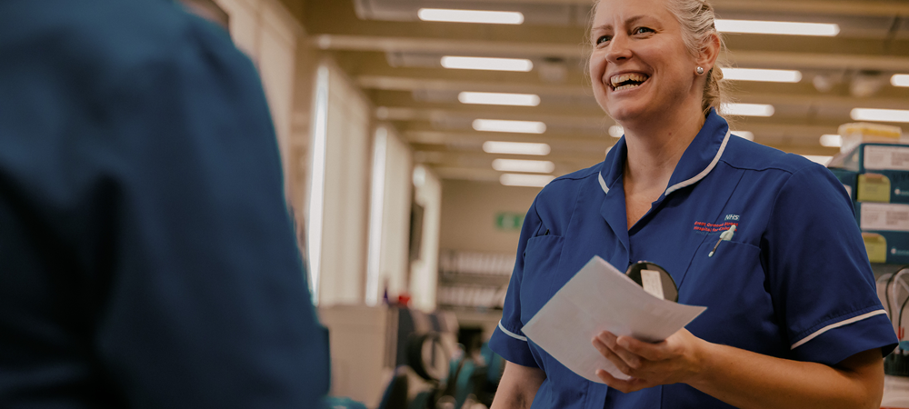 A woman smiling in a hospital corridor