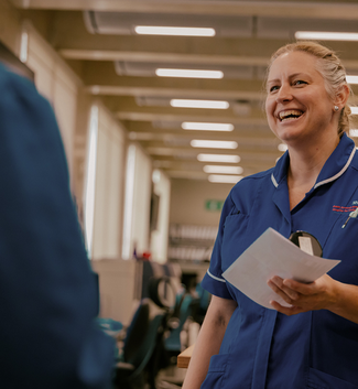 A woman smiling in a hospital corridor