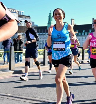 London Landmarks Half Marathon runner focussed and running past the GOSH cheer point