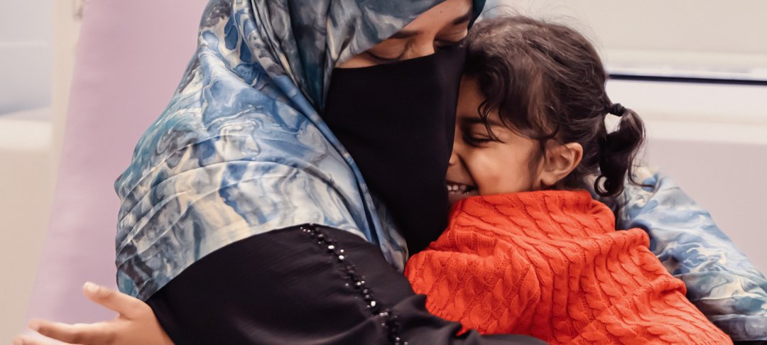 Little girl hugging her mum