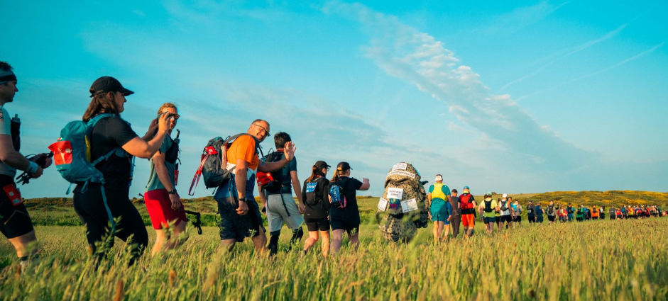 Trekkers in a field on the lake district challenge