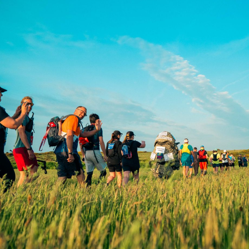 Trekkers in a field on the lake district challenge