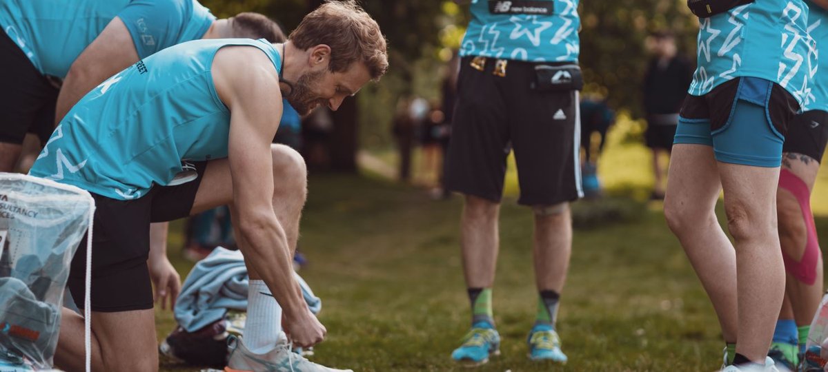 London Marathon runner tying shoelaces before the event
