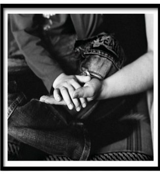 black and white photography print by Mary McCartney. Photo focuses on a child's hand being held by an adult hand