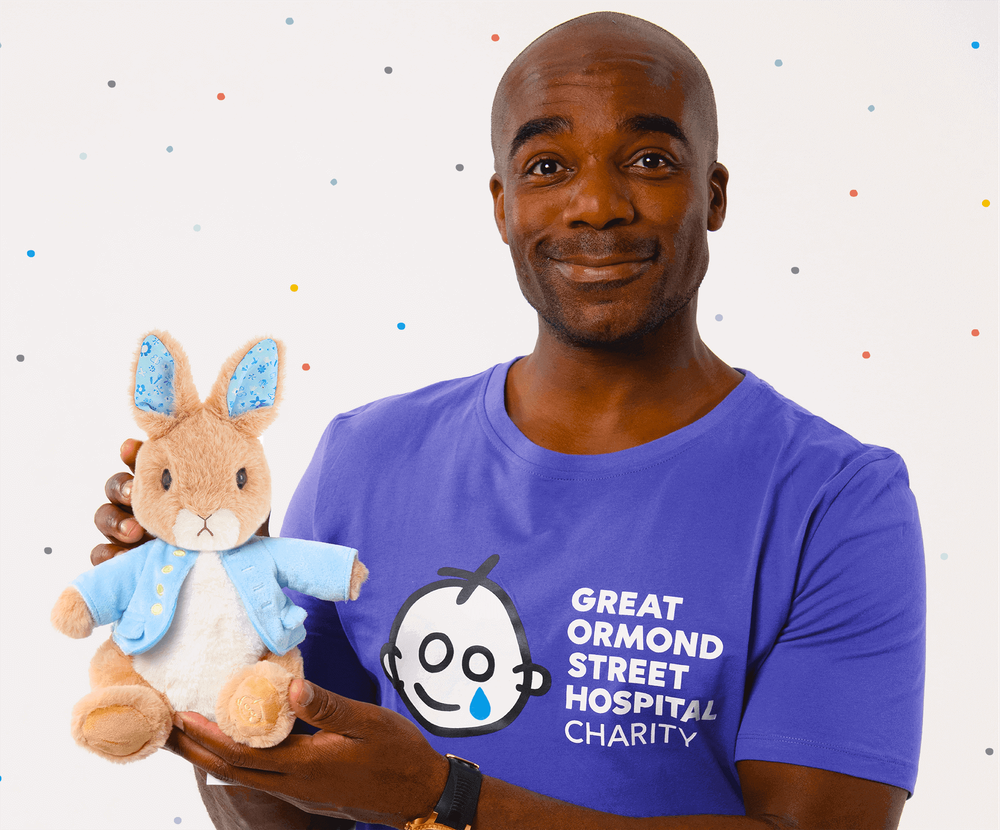 Ore_Oduba_with_gosh_peter_rabbit_toy_on_polka_dot_backdrop