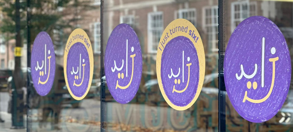 ZCR logo on vinyl stickers on window outside the building