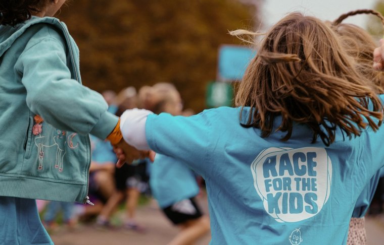 Two girls completing RBC Race for the Kids, holding hands
