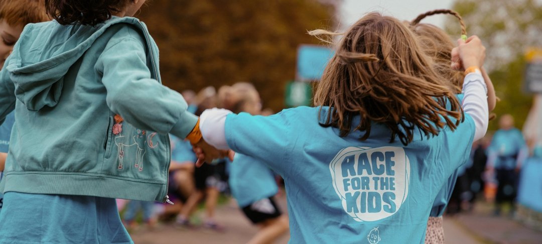 Two girls completing RBC Race for the Kids, holding hands