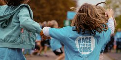 Two girls completing RBC Race for the Kids, holding hands