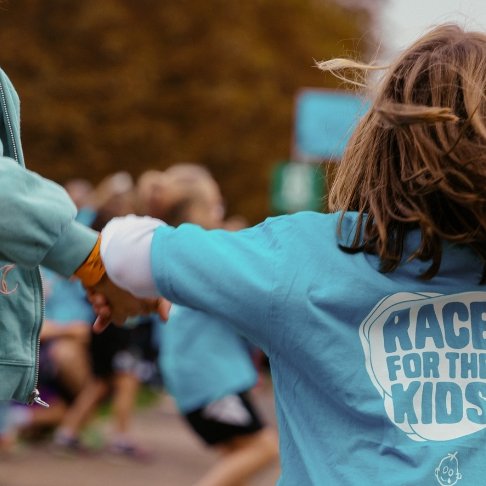 Two girls completing RBC Race for the Kids, holding hands