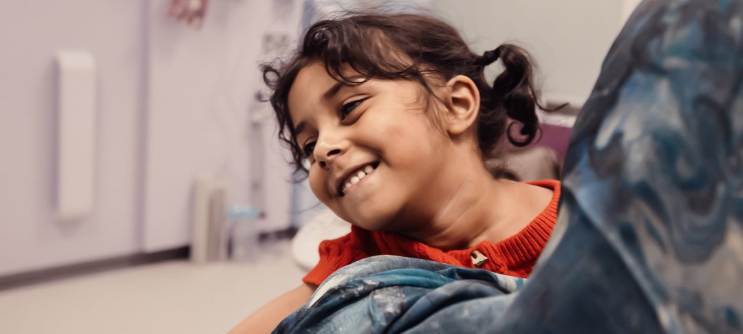 Little girl smiling in hospital corridor