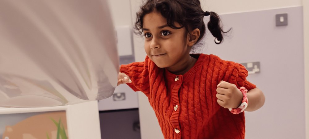 Little girl in hospital room with a defiant facial expression