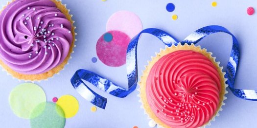 Cupcakes surrounded by confetti and ribbon