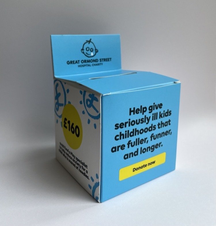 A cardboard collection box sits on a table
