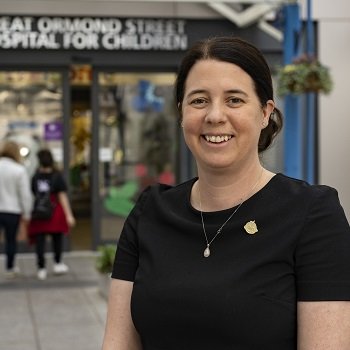 A portrait of Liz Tait, Director of Fundraising in front of Great Ormond Street Hospital.