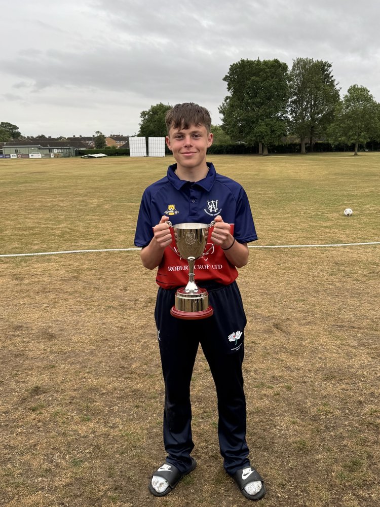 A teenager holding a trophy